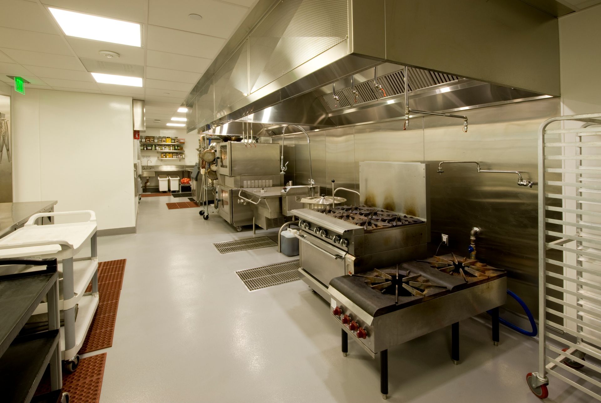 A large kitchen with a lot of stainless steel appliances