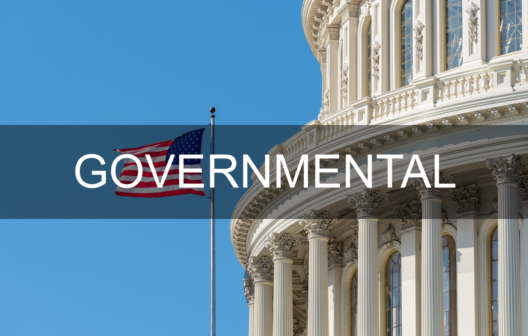 A flag is flying in front of the capitol building with the word governmental written above it.