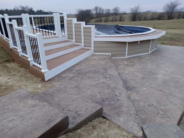 pool deck
concrete patio
outdoor kitchen
pergola
mahomet il