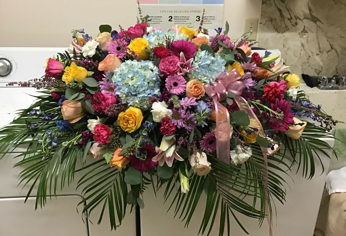 A large bouquet of flowers is sitting on top of a white table.