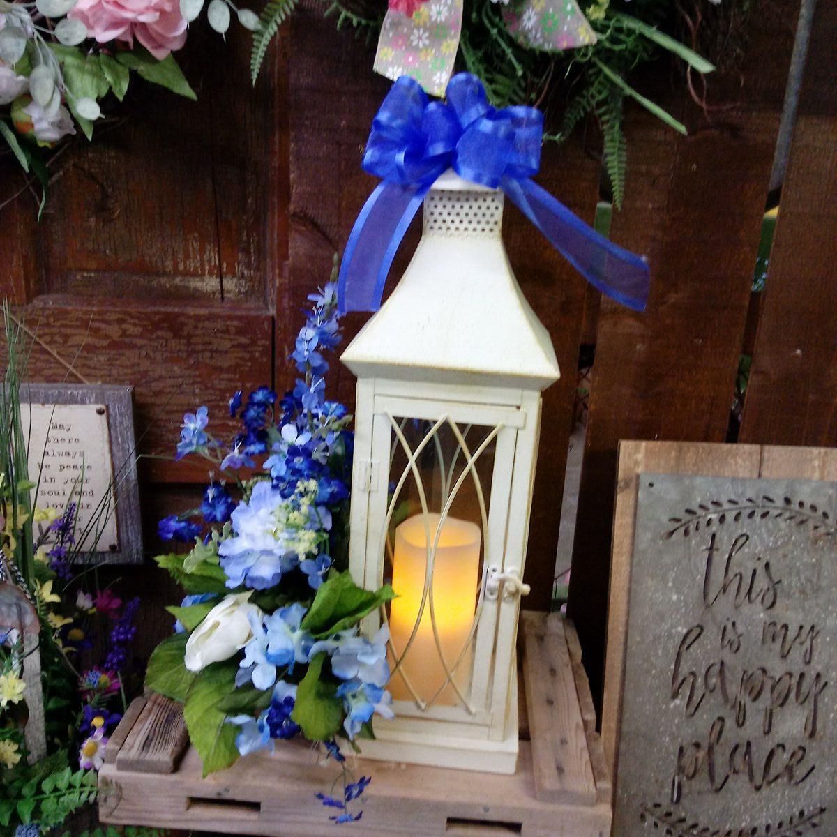 A sign that says this is a happy place next to a lantern