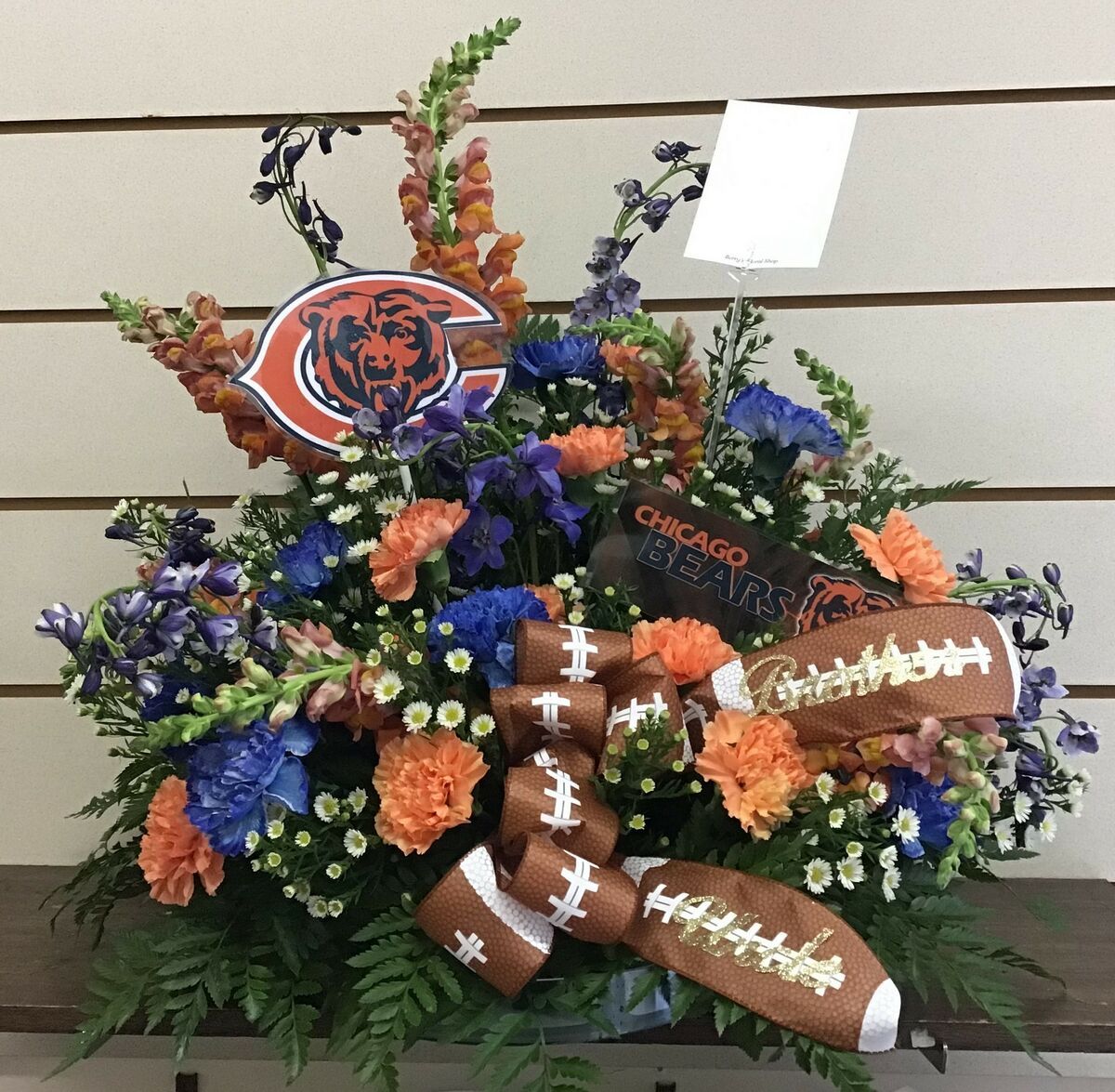A bouquet of flowers with a chicago bears logo on top