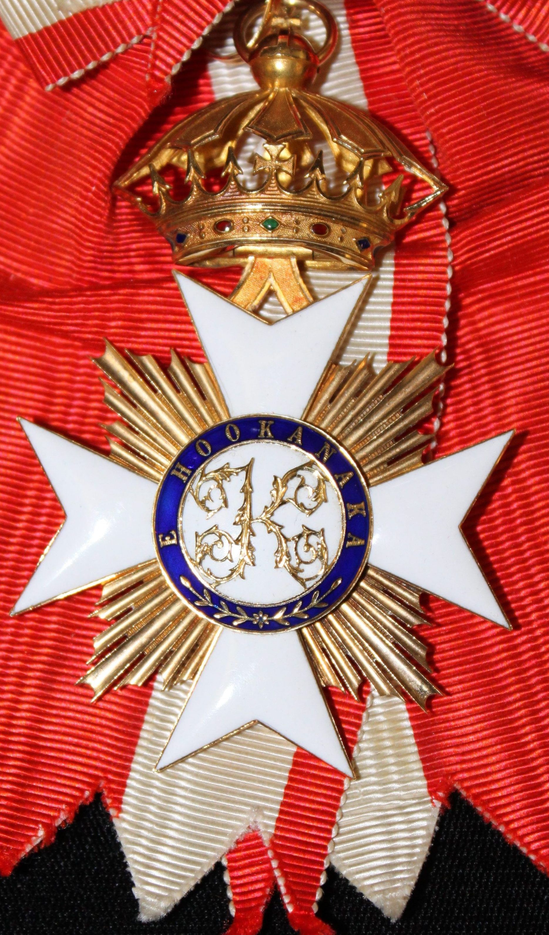 A gold and white cross with the number 14 on it.