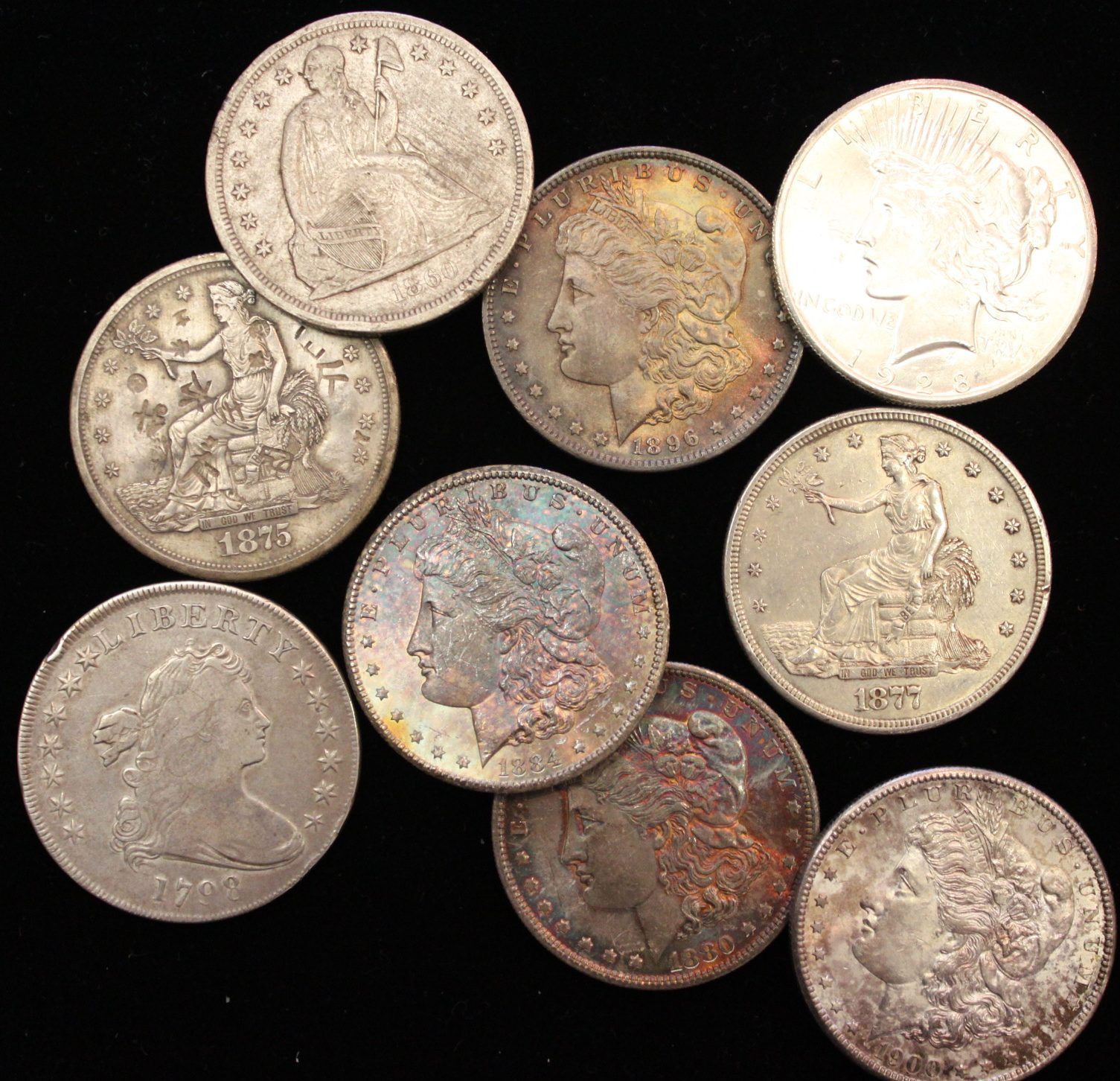 A bunch of silver coins with one that says liberty on it.