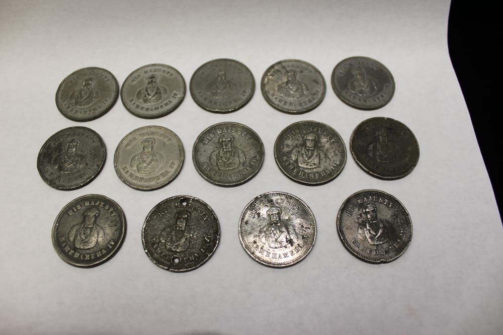 A display case filled with lots of coins on a table.