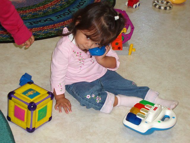 Little girl using toy phone - My Second Home - Concord, CA