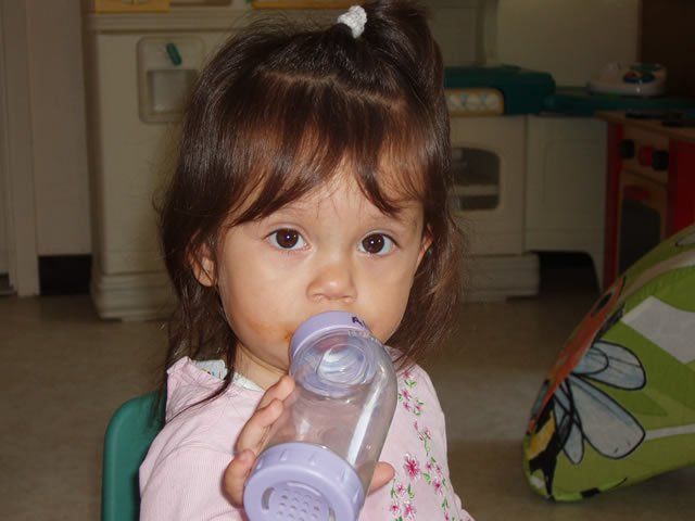 Infant girl drinking in feeding bottle - My Second Home - Concord, CA