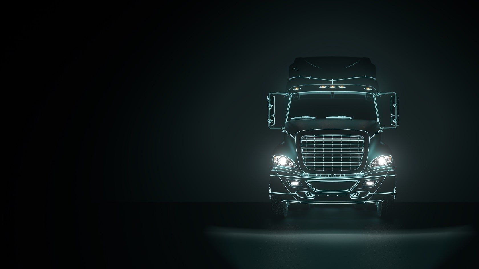 A semi truck is driving down a dark road at night.