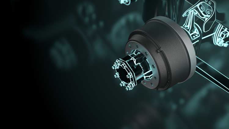 A close up of a brake drum on a dark background.