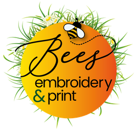 The logo for bees embroidery is surrounded by daisies and grass.