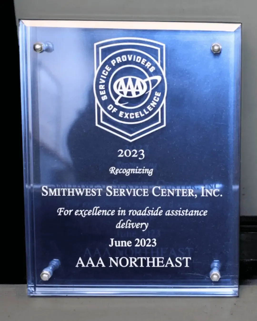 Plaque from AAA for Smithwest Service Center, Inc. for roadside assistance, 2023. Blue and silver. | Smithwest Service Center