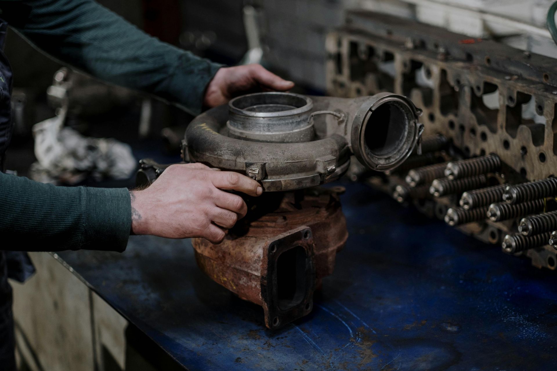 Mechanic Inspecting Turbocharger Component | Smithwest Service Center
