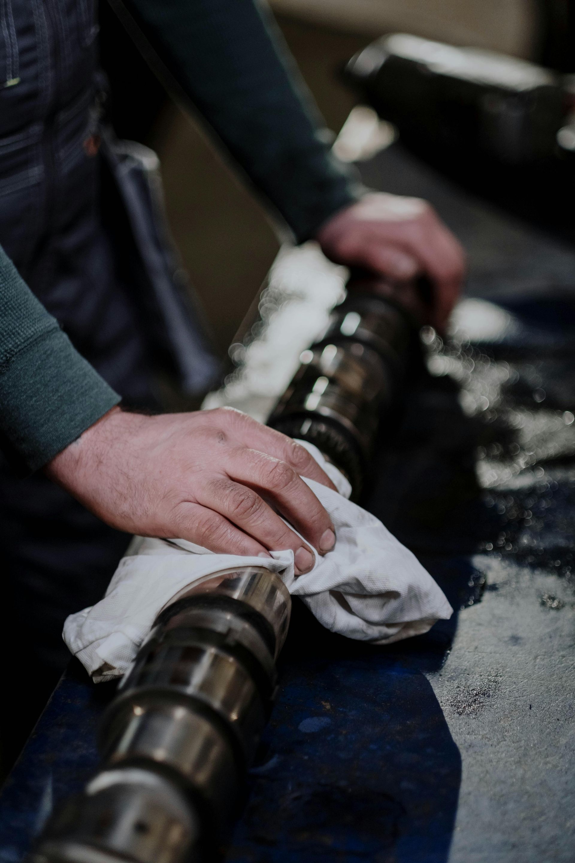 Technician Cleaning Engine Camshaft | Smithwest Service Center