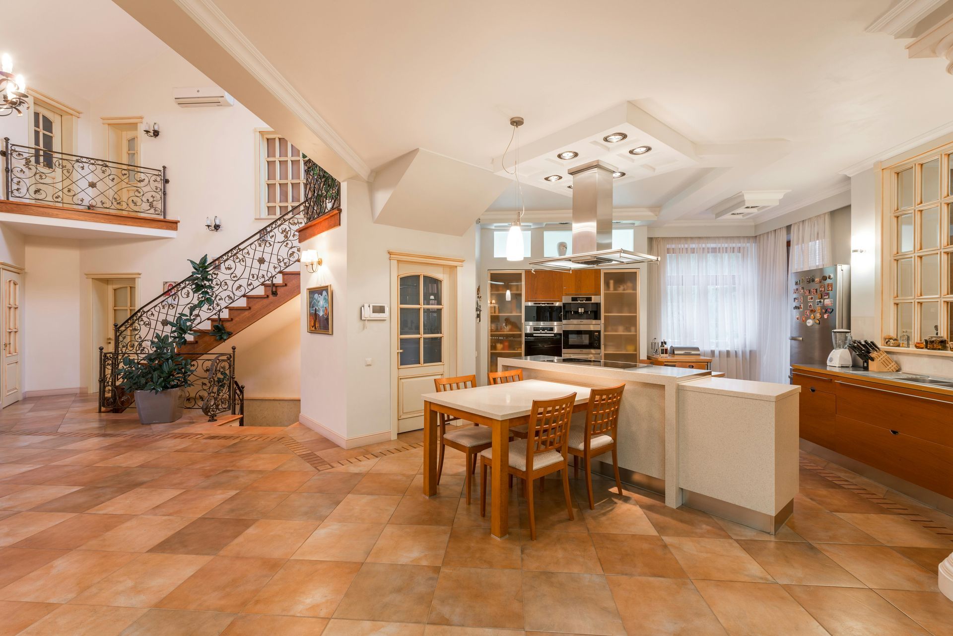 A large kitchen with a table and chairs in it
