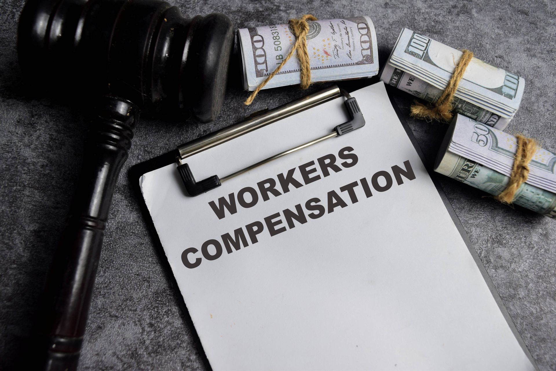 Concept of workers' compensation written on paperwork placed on a table.