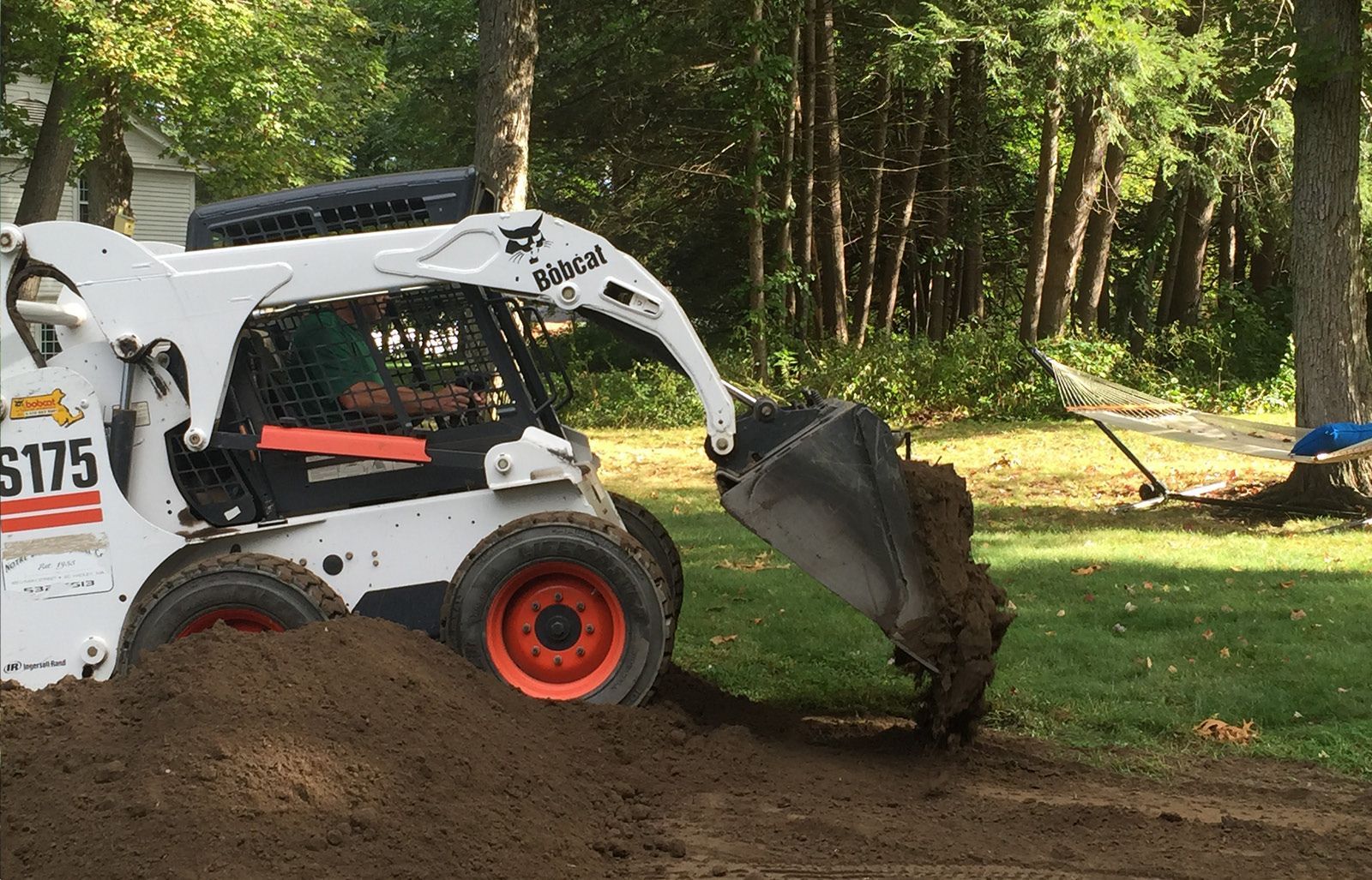 a man is cutting a tree with a  chainsaw