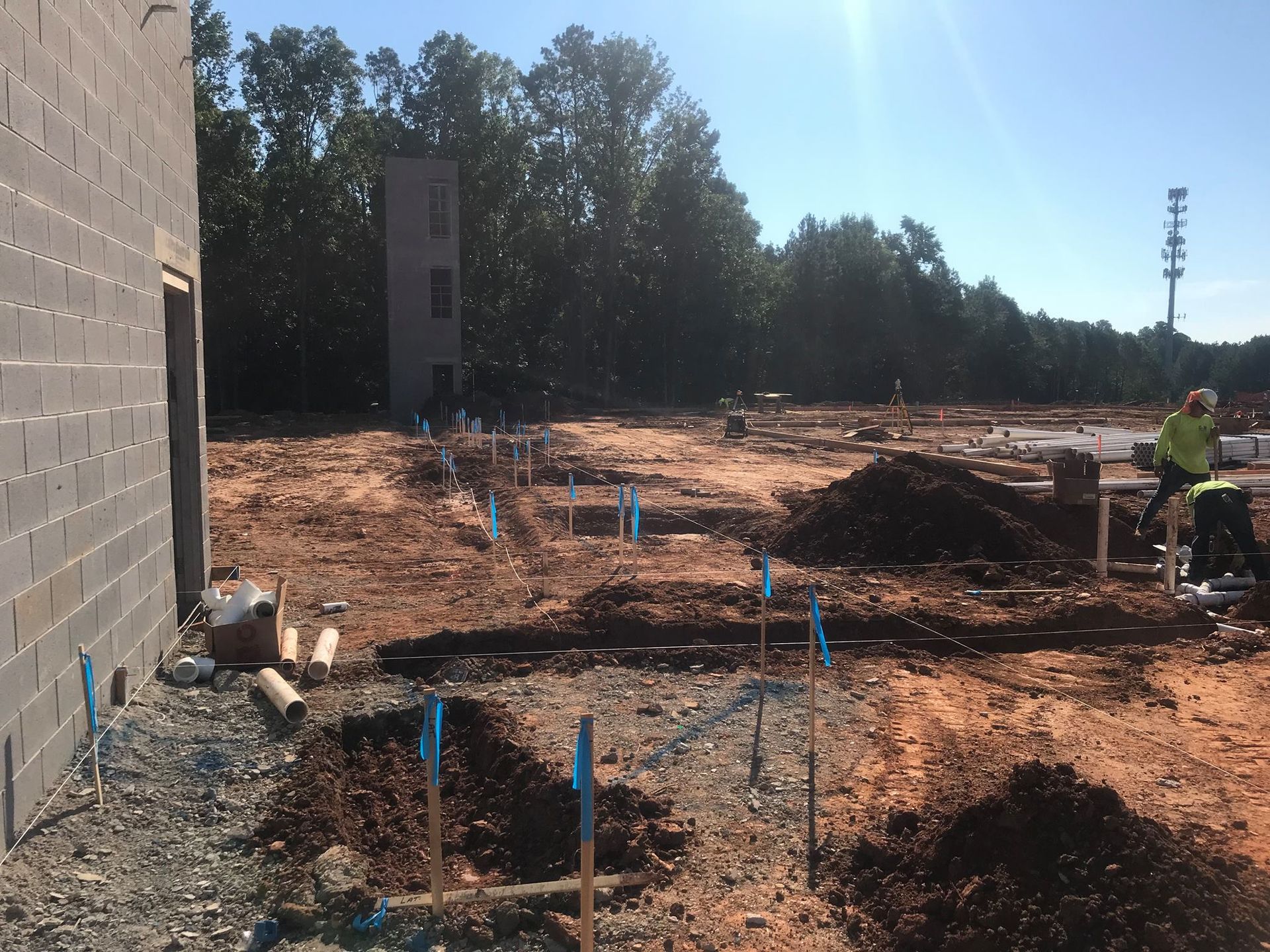 a construction site with a brick building in the background