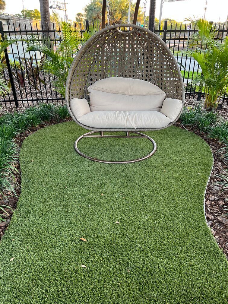 turf below a swing at a common area of a Tampa apartment complex mixed with landscaping