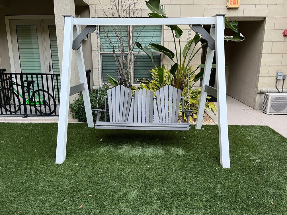 family swing positioned on turf within the courtyard of a Ybor City apartment