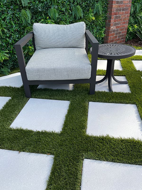 12x12 white limestone in between diamond pattern green turf 