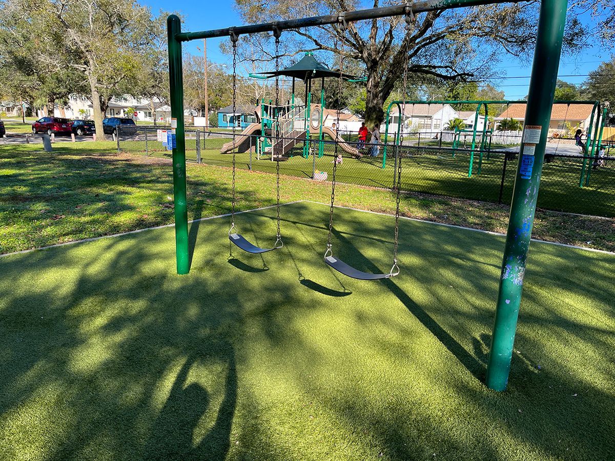 swings and complete playground built on soft turf in St. Petersburg, FL