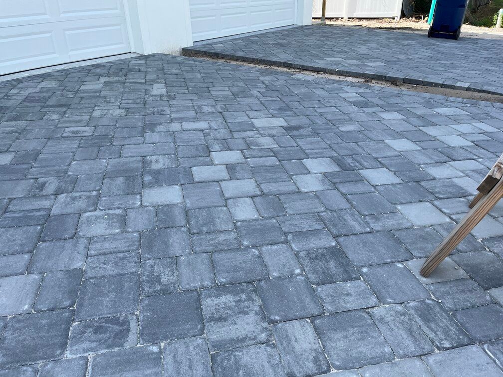 two new paver driveways laid in front of each garage