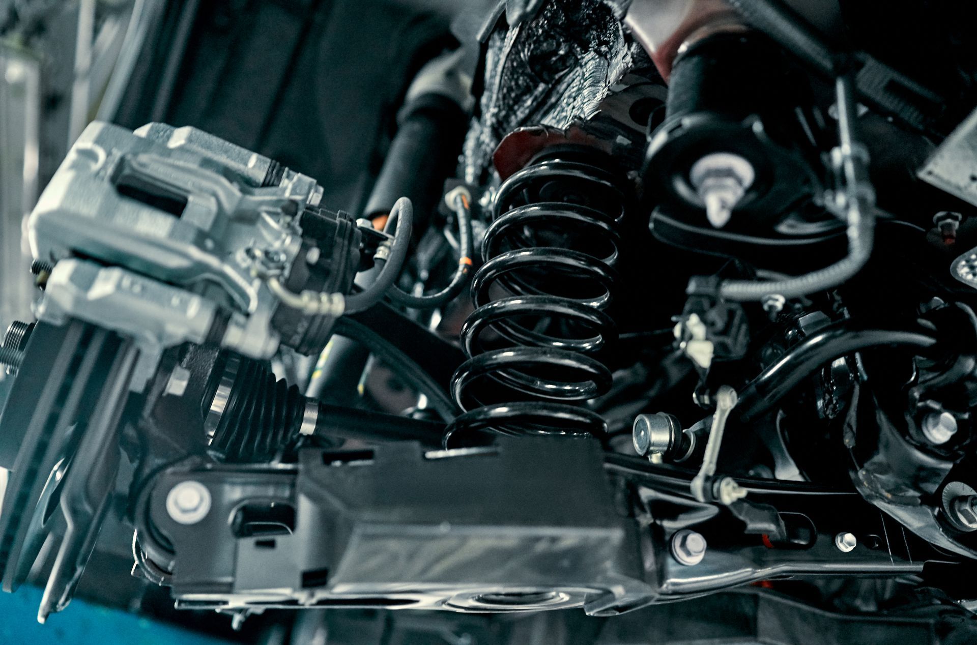 A close up of the underside of a car 's suspension system.