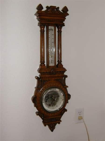 A clock with a thermometer attached to it