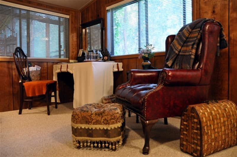 A living room with a red leather chair and ottoman