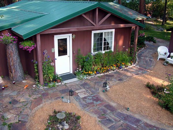 An aerial view of a small house with a green roof
