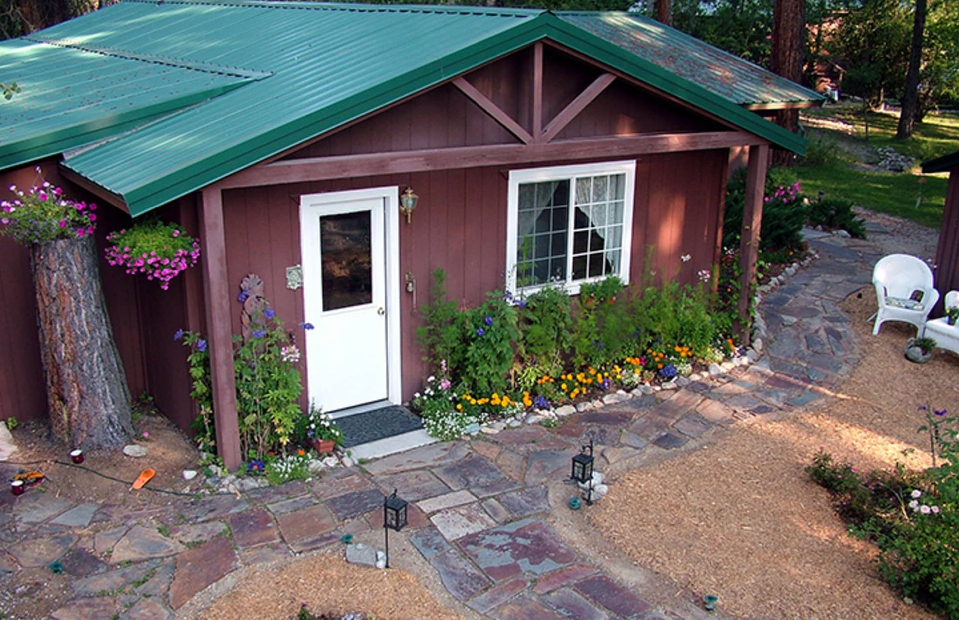 An aerial view of a small house with a green roof