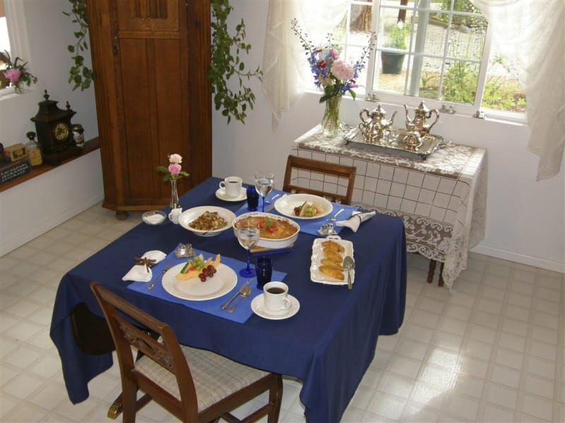 A table with plates and bowls of food on it