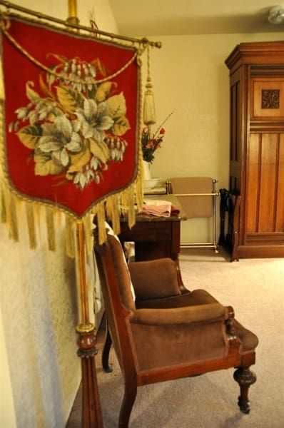 A red banner with flowers on it hangs above a chair