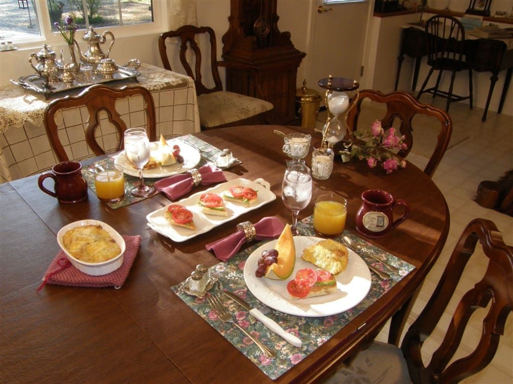 A table with plates of food and glasses of orange juice