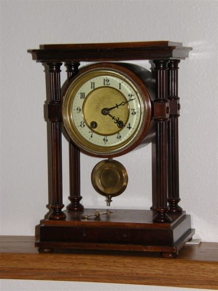 A clock with the hands on the numbers 1 and 12