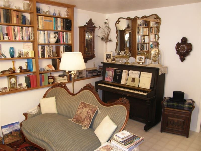 A living room with a couch and a piano