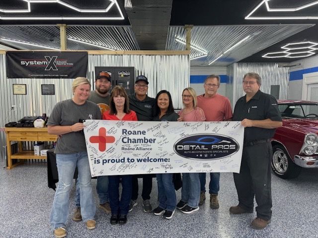 A black corvette is parked in a garage.