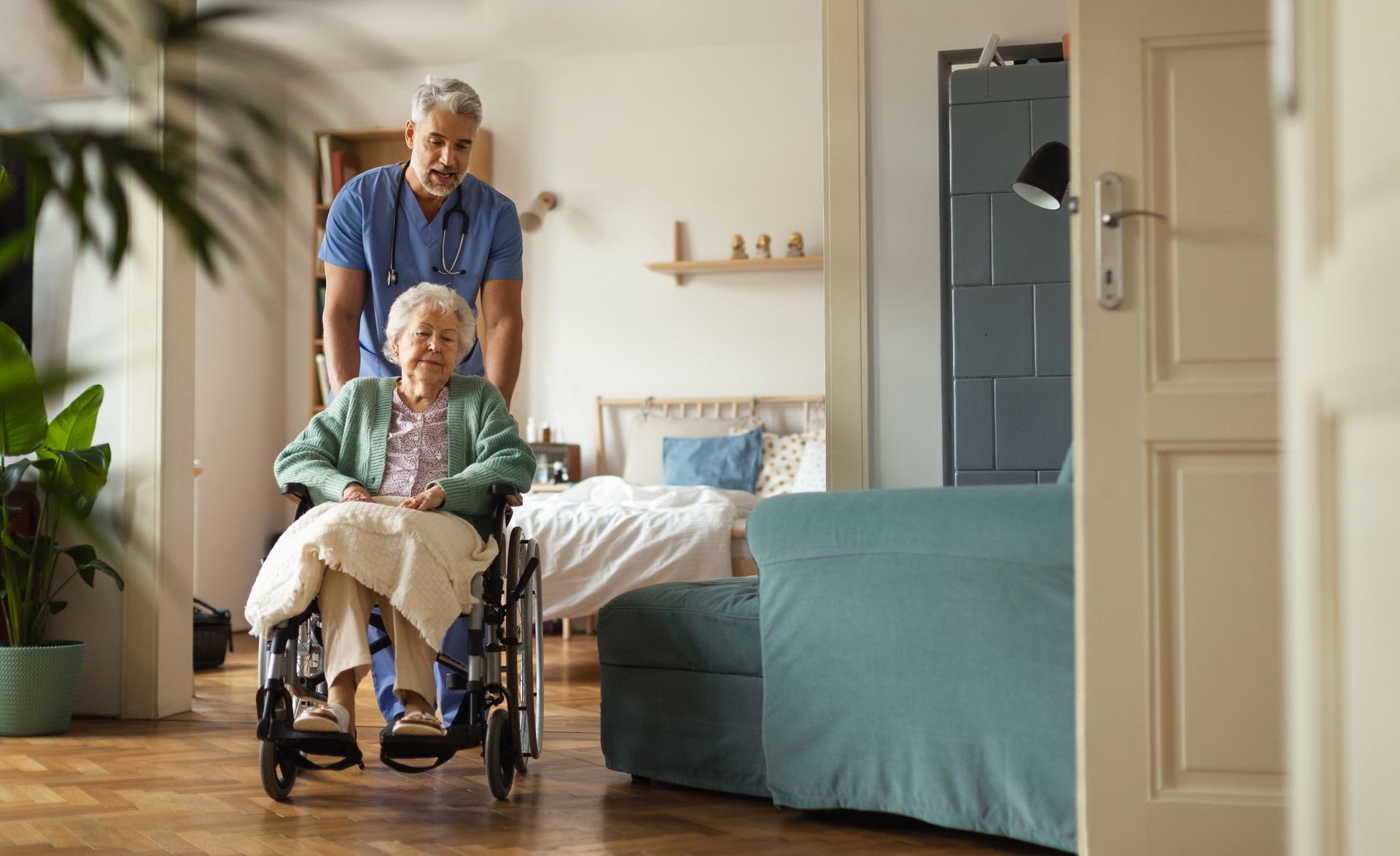 person pushing elderly person in a wheelchair