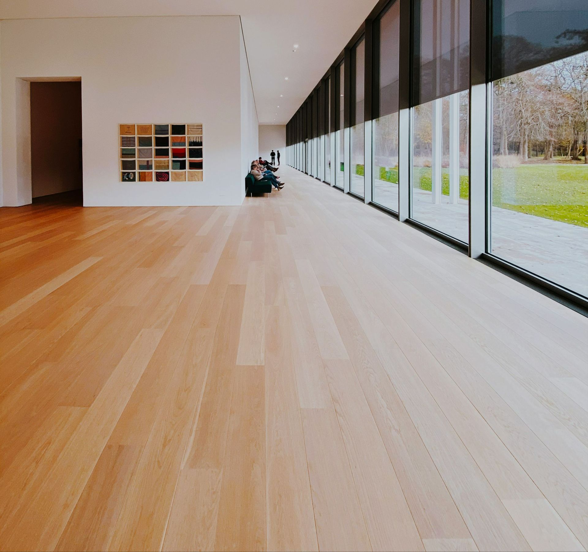 A room with a lot of windows and a wooden floor