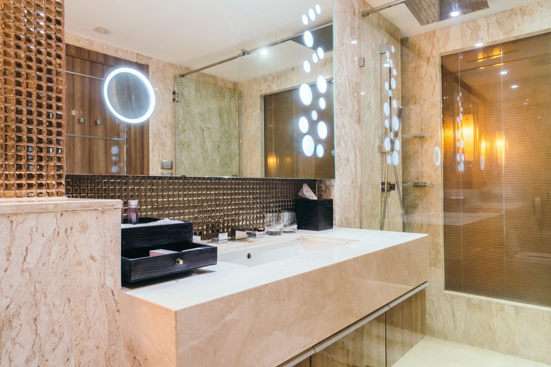 A bathroom with a sink , mirror and shower.