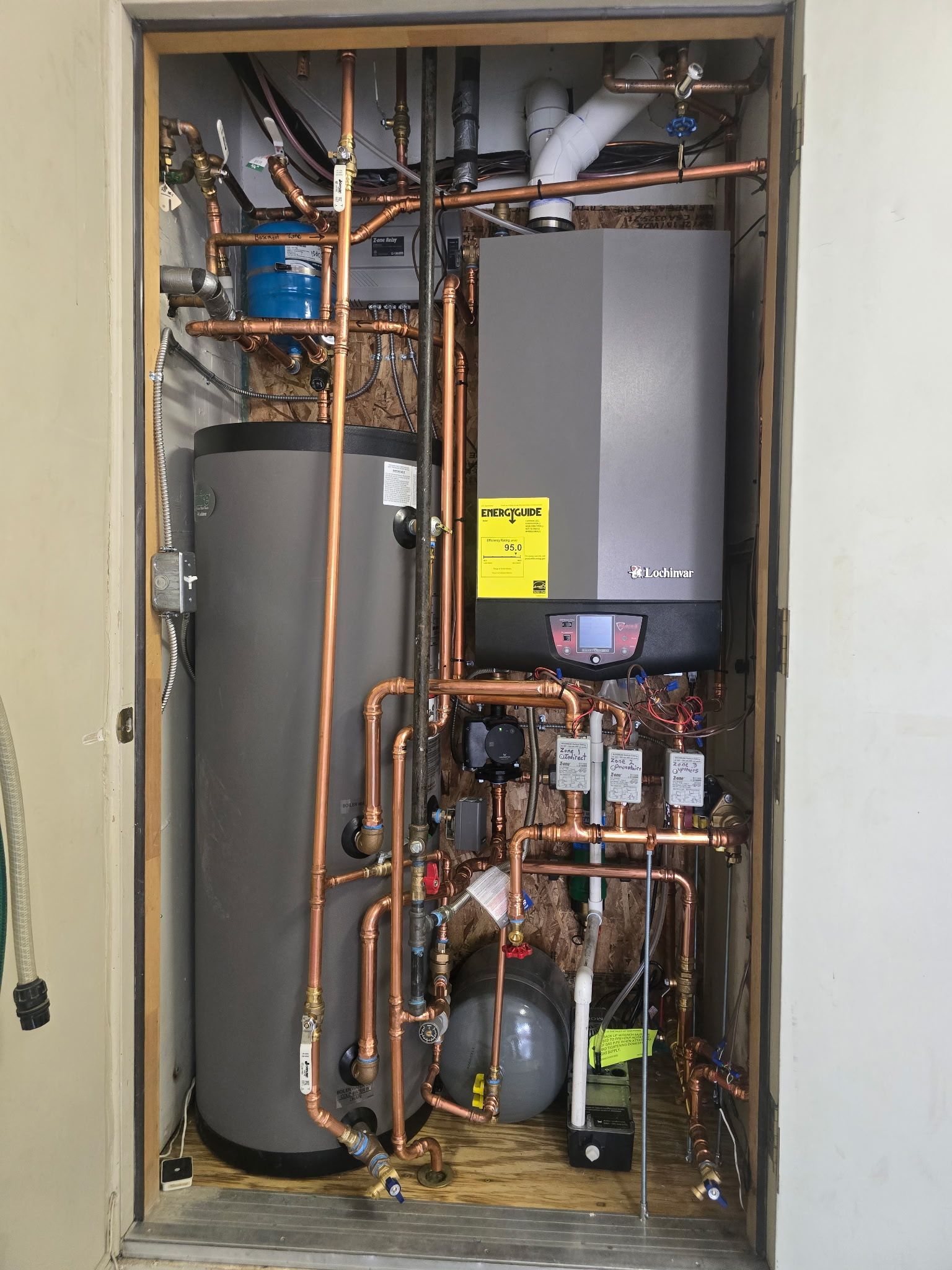 Dark-cabinet kitchen with a window above the sink, light countertops, and an unfished dishwasher.