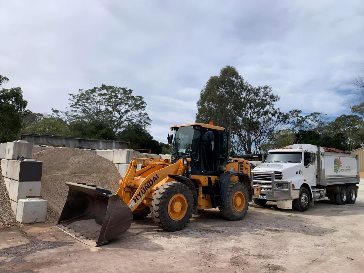 A Bulldozer is Parked Next to a Sand — Black Rock Garden Centre In Tyagarah, NSW