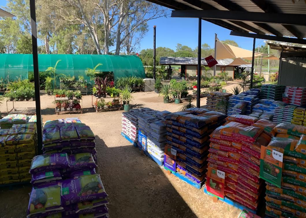 A Bunch of Bags of Fertilizer Are Sitting on a Shelf in a Garden Center — Black Rock Garden Centre In Tyagarah, NSW