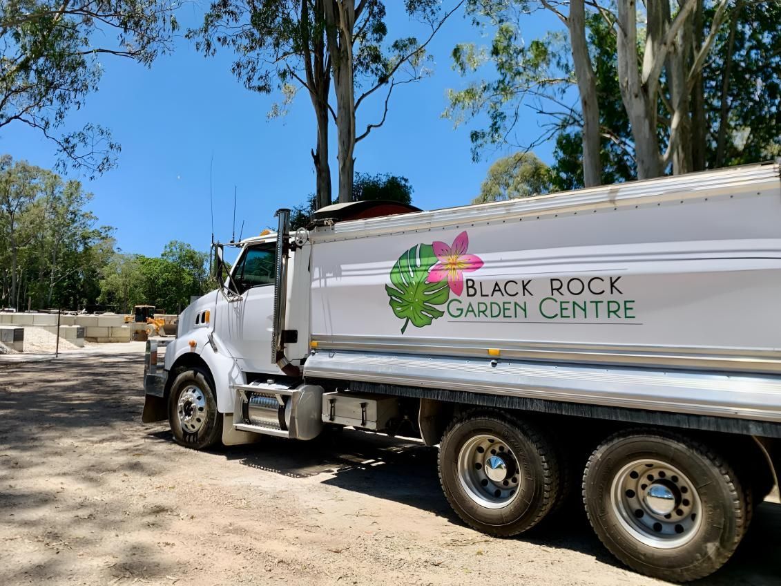 A White Dump Truck is Parked on the Side of the Road — Black Rock Garden Centre In Tyagarah, NSW