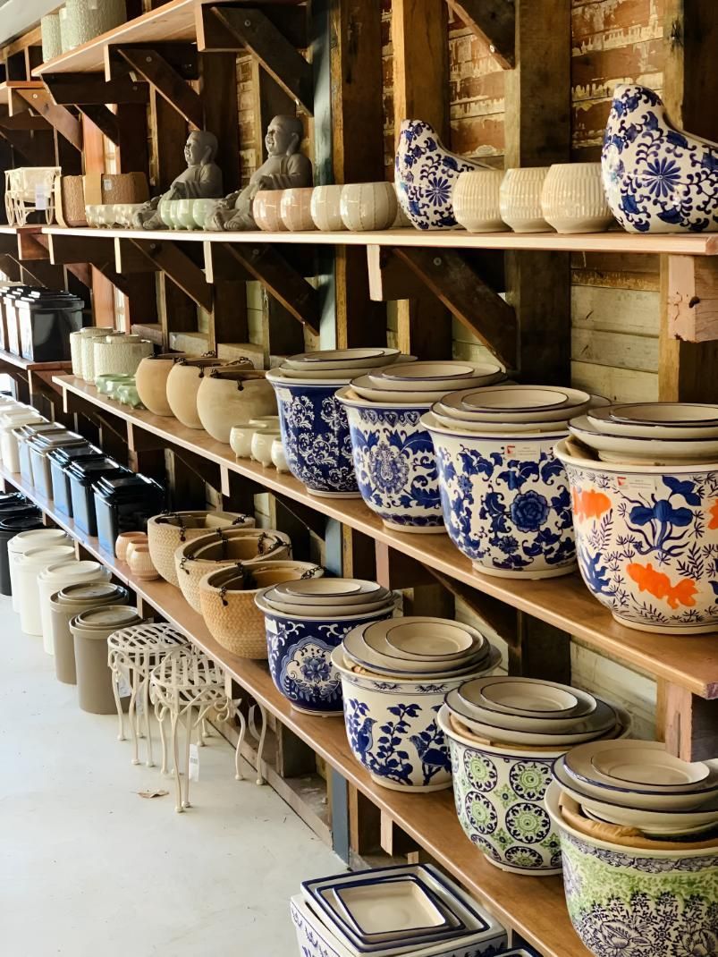 A shelf of pots in a barn styled shed — Black Rock Garden Centre In Tyagarah, NSW