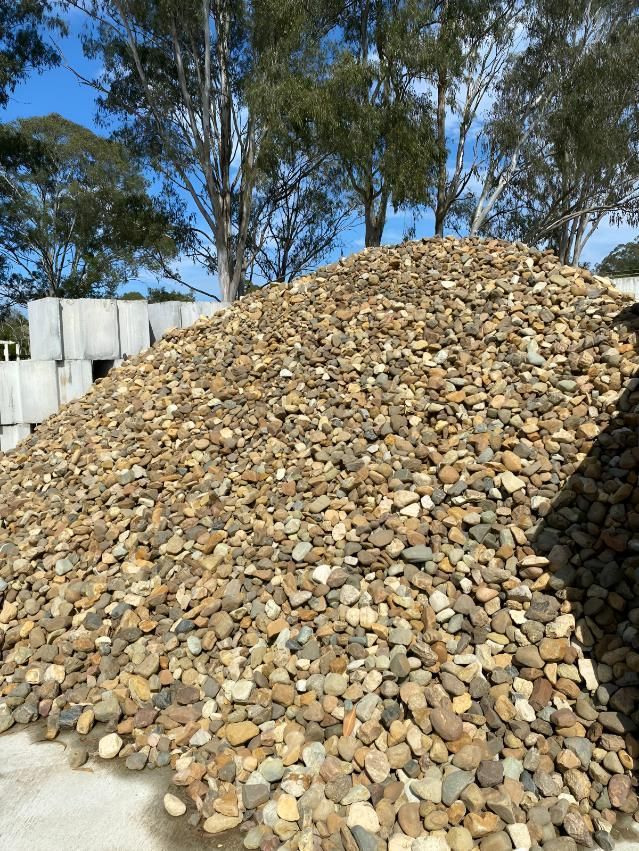 A Large Pile of Rocks is Sitting on Top of a Concrete Surface — Black Rock Garden Centre In Tyagarah, NSW