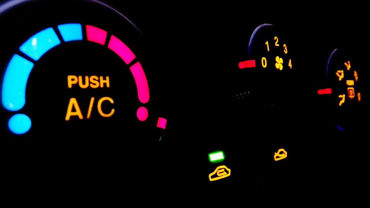 A close up of a car dashboard that says push a / c