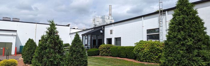 Press Enterprise Commercial Printing building with a lot of trees in front of it.