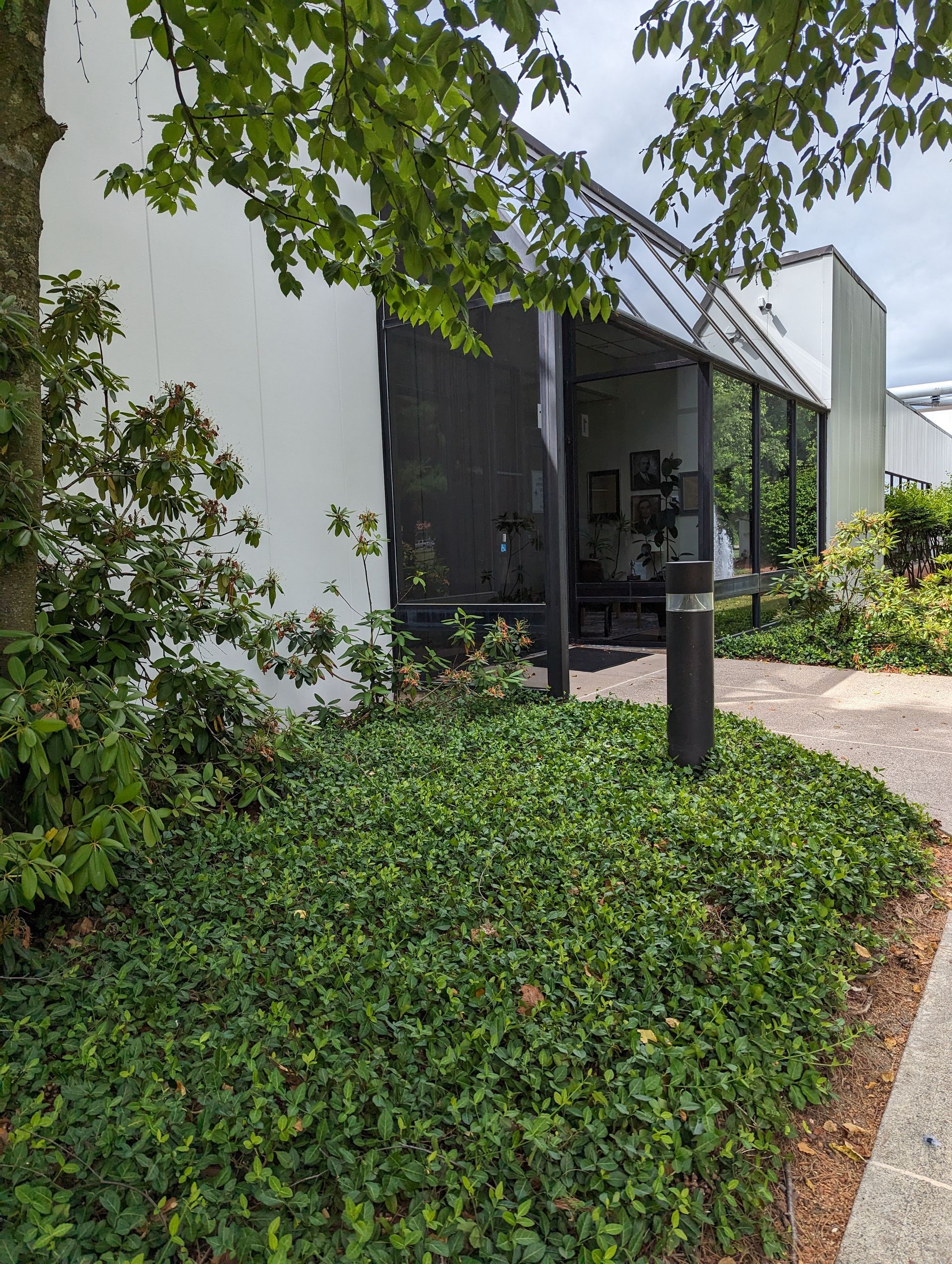 Press Enterprise Commercial Printing building with a lot of windows and trees in front of it.