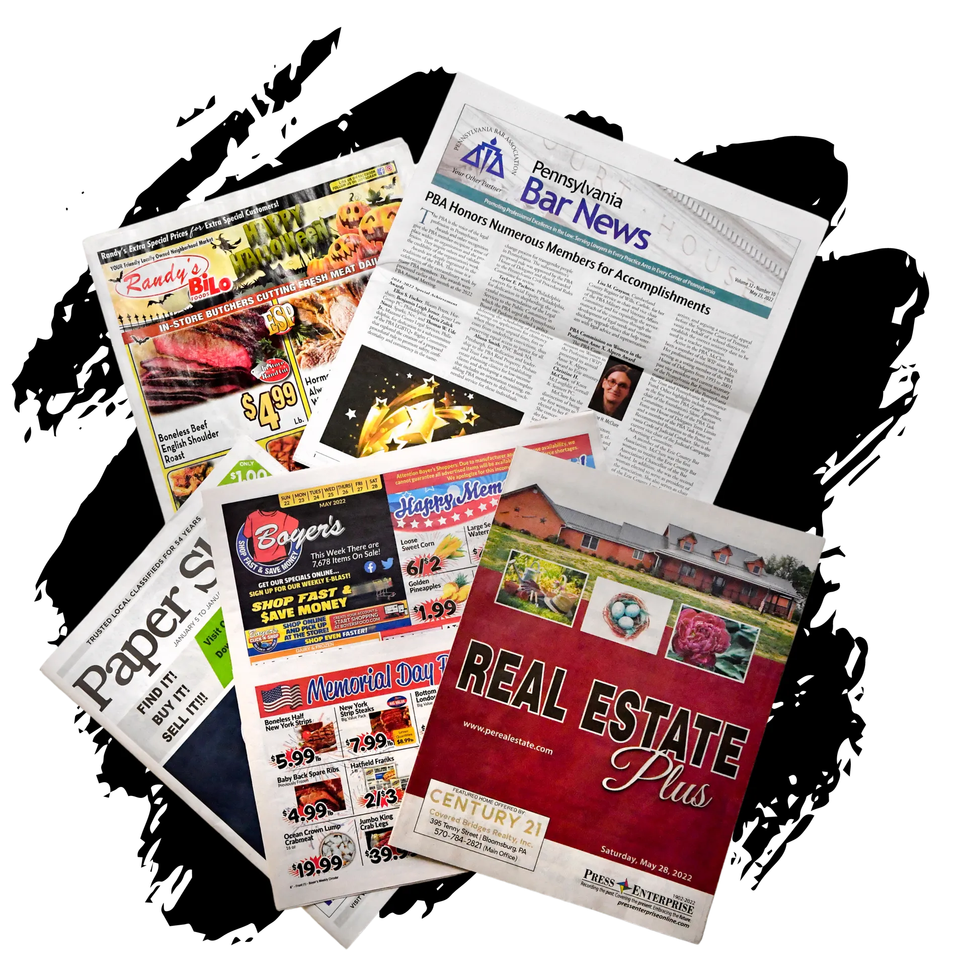 A bunch of newspapers including one that says real estate plus